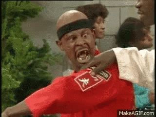 a man wearing a red shirt with a domino 's logo on it is being punched in the face .