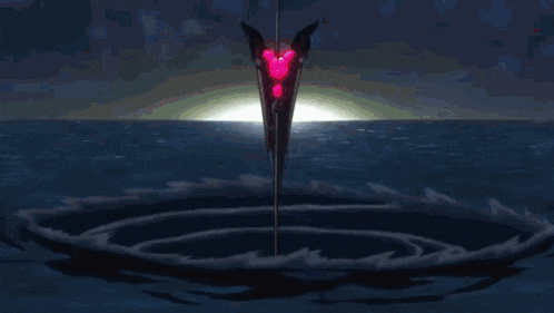a sword with a red heart on it is in the water
