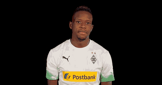 a man wearing a white shirt with the word postbank on the front