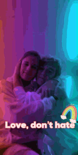 a couple taking a picture with a rainbow in the background