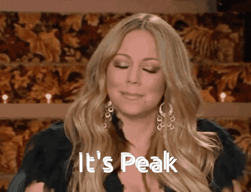 a woman says it 's peak in front of a floral backdrop