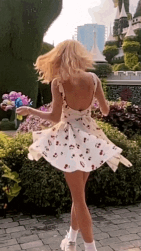 a woman in a white dress with flowers on it