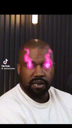 a man with a beard is wearing a white shirt and has pink flames coming out of his head .