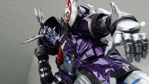a close up of a purple and silver robot with a sword