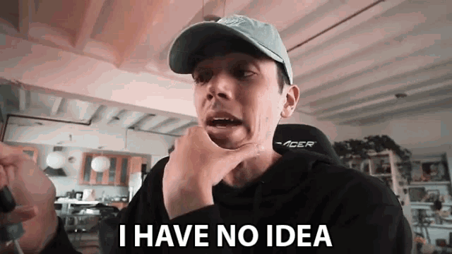 a man wearing a hat and a hoodie says i have no idea