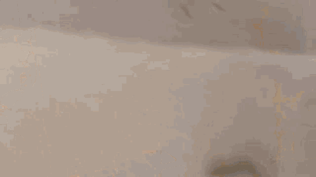 a blurred image of a person walking on a sidewalk in a city .