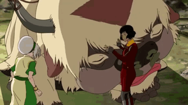 a woman in a red suit is standing next to a giant animal .
