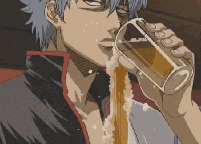 a man is drinking a glass of beer with foam coming out of his mouth