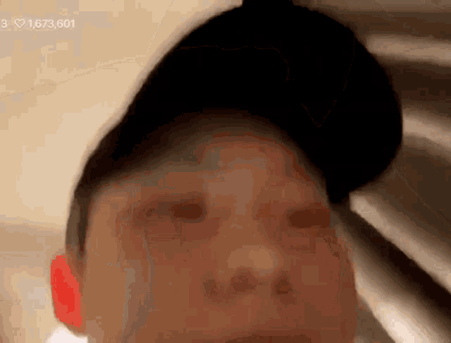 a close up of a person 's face with a hat on and the number 3 in the corner