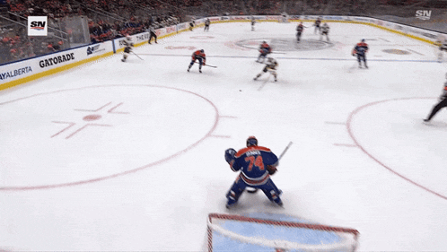 a hockey game is being played in front of a gatorade sign