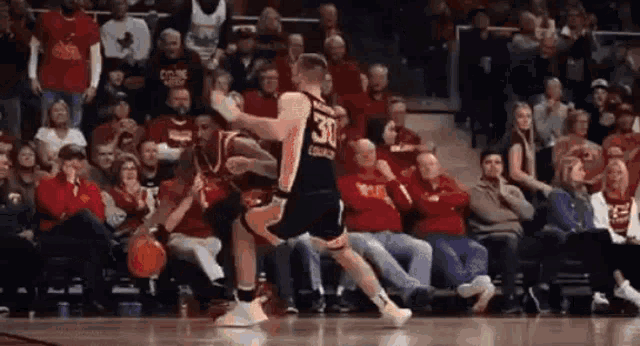 a basketball player with the number 30 on his jersey is dribbling a basketball