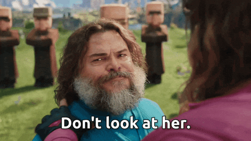 a man with a beard says " don 't look at her " while standing next to a woman