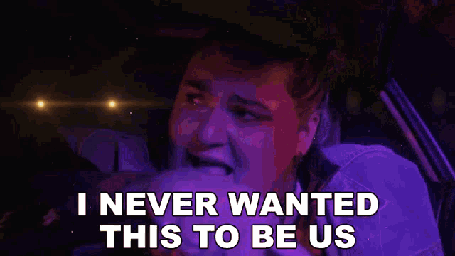 a woman is crying in a car with the words i never wanted this to be us