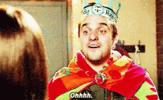 a man wearing a crown and a colorful blanket says ohhhh