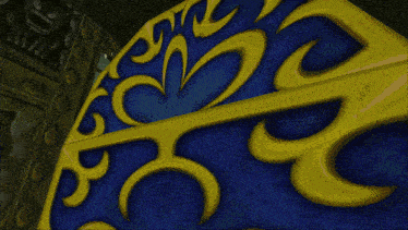 a blue and yellow item with a swirl design