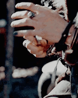 a woman 's hand with a ring on her finger