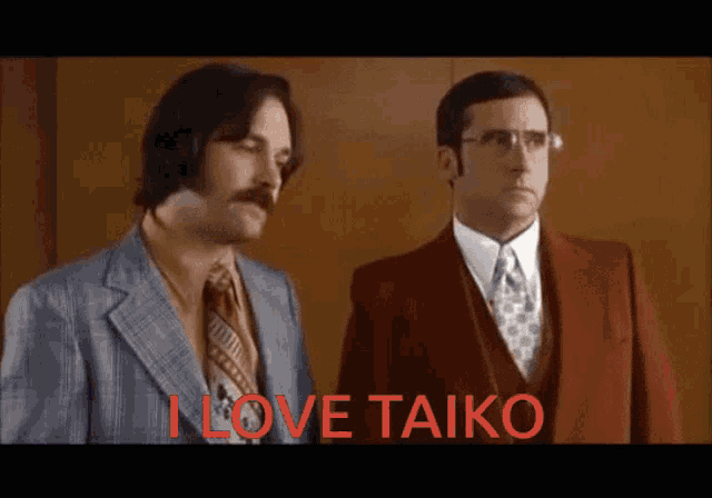 two men standing next to each other with the words " i love taiko " in red letters