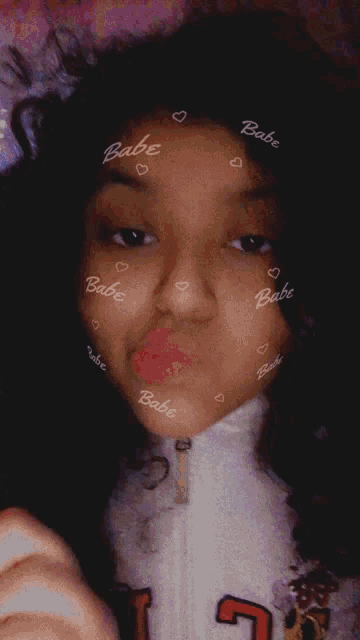 a girl has the word babe written on her face