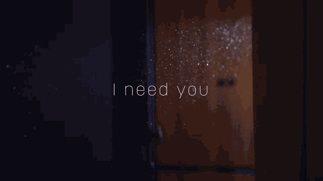 a dark room with the words i need you on it