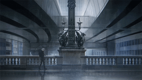 a man holding an umbrella walking in the rain