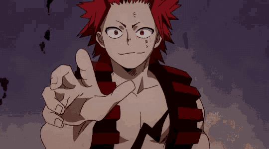 a cartoon character with red hair and a striped shirt is pointing his finger at the camera .