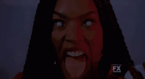 a woman with white eyes is making a funny face with her tongue out .