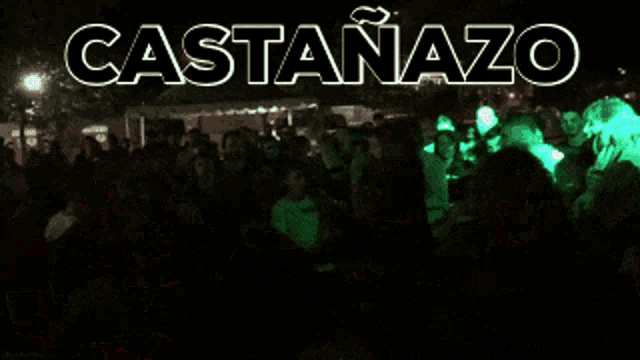 a crowd of people are dancing in front of a sign that says castahazo