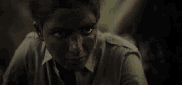 a close up of a woman 's face with a dark background