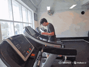a man is running on a treadmill in a gym sponsored by minimaxel
