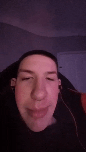 a close up of a man 's face with headphones on