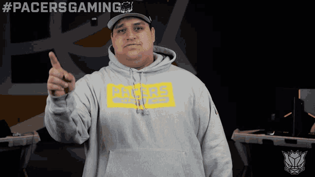 a man wearing a pacers hoodie points his finger