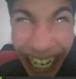 a close up of a man 's face with a fake smile on his face .