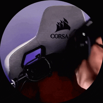 a man wearing glasses and headphones is sitting in a chair with a microphone .