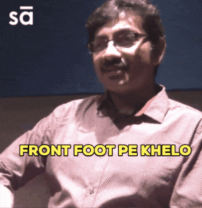 a man with glasses and a mustache says " front foot pe khelo "