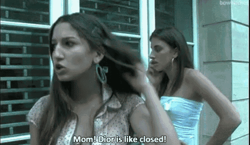 two women are standing next to each other and one of them is saying `` mom , dior is like closed ''