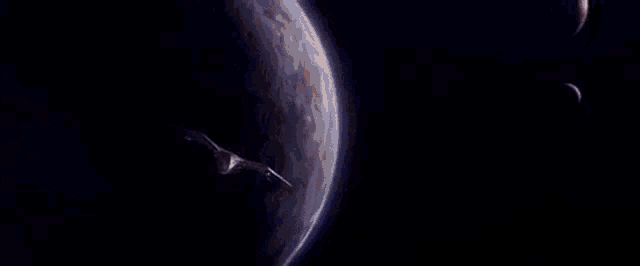 a space ship is flying through a galaxy in a dark space scene .