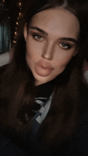 a woman sticking her tongue out while wearing a black shirt that says reebok