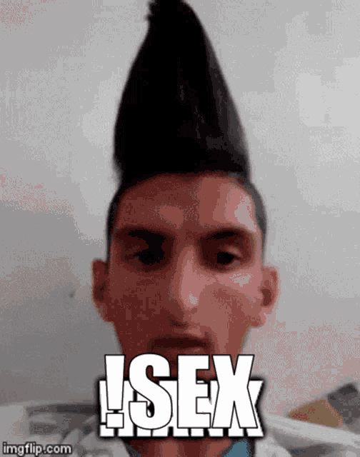 a man with a mohawk and the word sex on his face .