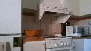 a kitchen with a stove top oven and a hood