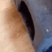 a close up of a tire on a wooden floor with a hole in it .
