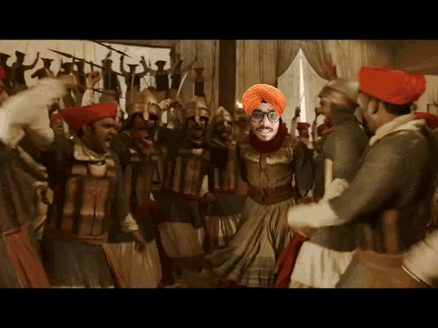 a man wearing a turban and glasses is surrounded by other men