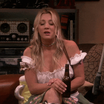 a woman sitting on a couch with a bottle of beer