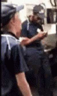 a blurry picture of a man standing next to another man in a restaurant .