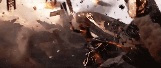a group of people are flying through the air while a plane is crashing into a building .