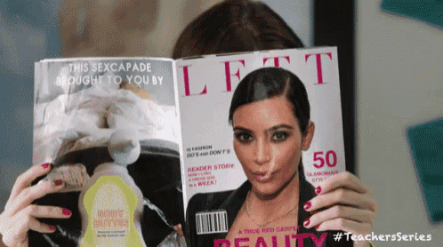 a woman is holding a left magazine with a picture of kim kardashian on the cover