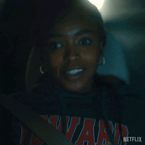 a woman sitting in a car wearing a netflix shirt