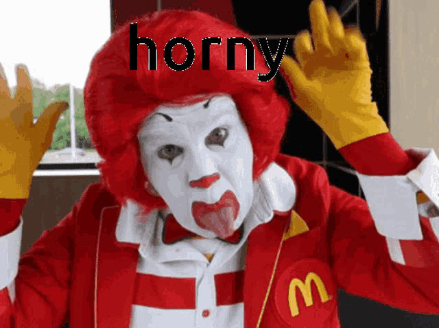a mcdonald 's clown with horny written on his red hair