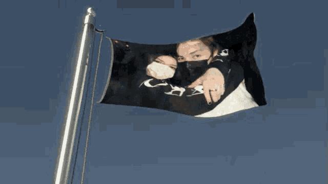 a black flag with a picture of a man and a woman on it