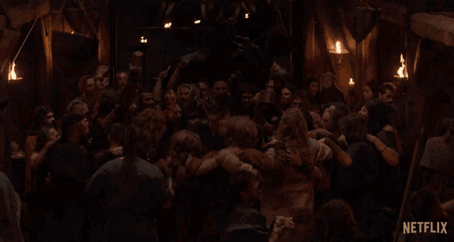 a crowd of people are gathered in a dark room with a netflix logo on the bottom right
