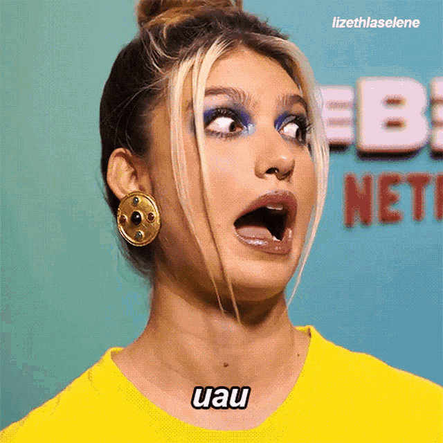 a woman making a funny face with the words uau written on her neck